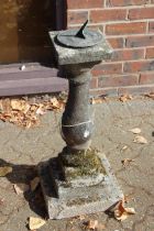 A garden sundial on a plinth.