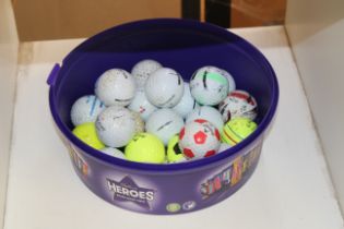 A tub of golf balls.