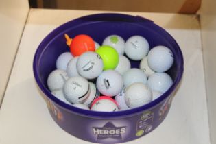 A tub of golf balls.