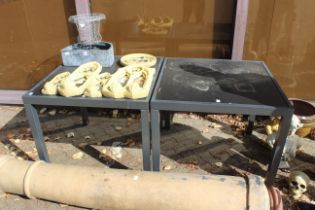 A pair of square outdoor tables.