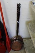 A copper bed warming pan.