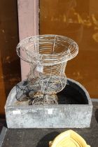 A semi circular outdoor planter and a wire planter.