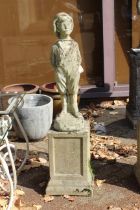 A garden statue of a whistling boy on a plinth.
