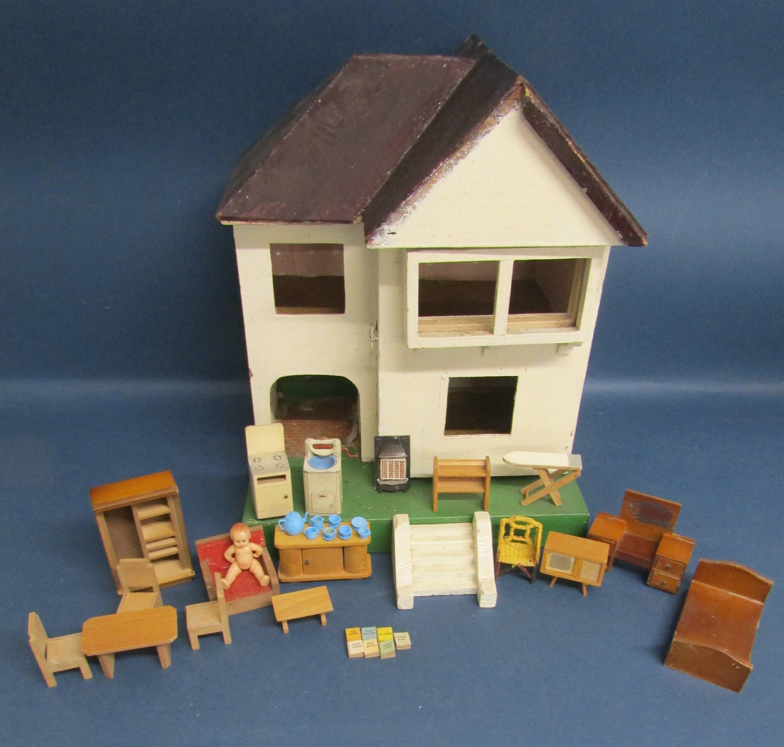 Dolls house with furniture includes metal mangle, fire and tea set, wooden furniture some with
