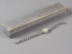 A silver and marcasite ladies watch, a silver cased fob watch, a silver Celtic style brooch and