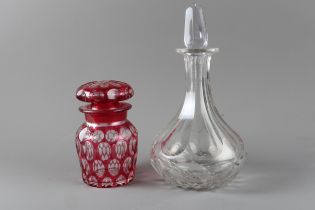 A ruby overlaid cut glass preserve jar and cover and a late 19th century decanter and stopper,
