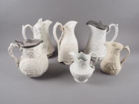 An early Victorian Parian ware relief moulded jug, "Samuel & Eli", 9" high, a similar
