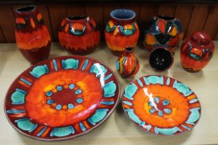 Four pieces of Poole pottery “Volcano” pattern china including a purse vase, a classic vase,