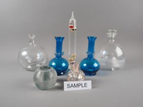 Two glass wasp traps and stoppers, a pair of blue glass vases, a glass vesta and a quantity of other