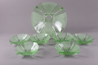 An Art Deco moulded uranium style glass bowl set including a 10 1/2” bowl and six 5 1/2” bowls
