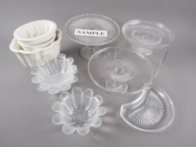 Three moulded glass cake stands, seven moulded glass grapefruit dishes formed as sunflowers, a bowl,