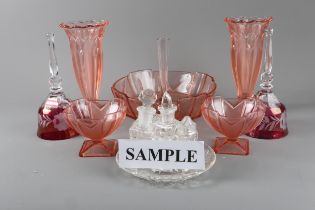 An Art Deco style moulded red coloured glass set, red overlaid glass bells, a part cruet set and a