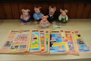 A Wade NatWest Piggy Bank family, eleven issues of “NatWest Piggy Press” magazines, and a Piggy Bank