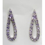 A pair of silver and purple stone eardro