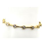 A silver and white stone heart bracelet,