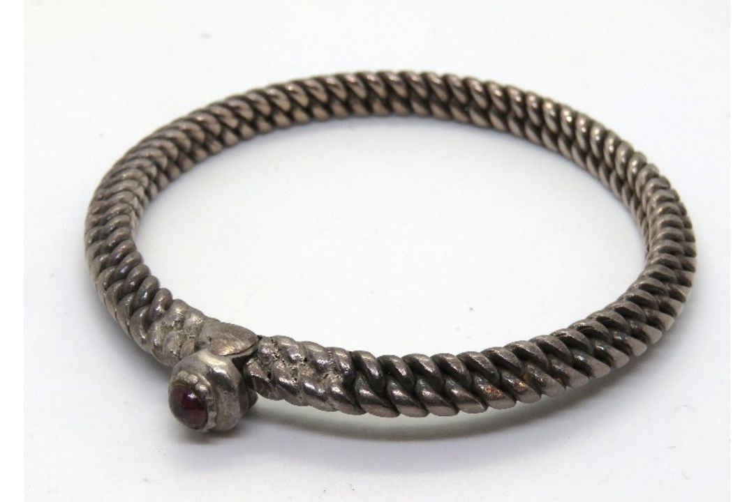 A heavy hand made bangle, no apparent ha