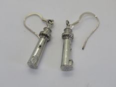 A pair of lighthouse themed earrings.