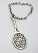 A heavy silver tennis themed keychain, 1