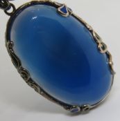 A large silver and blue stone pendant, 5