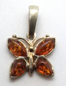 A silver and amber butterfly pendant, 24