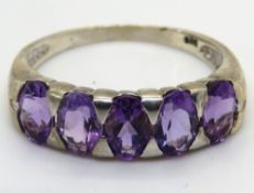A silver and purple stone ring, stamped