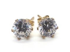 A pair of white stone stud earrings, buttlerfly backs stamped 9ct.