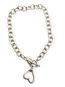 A hallmarked silver bracelet having heart tag upon.