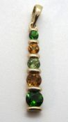 An autumnal coloured gemstone pendant in 9ct gold, set with peridot, citrine and diopside,