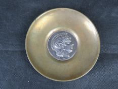 A brass dish having 925 silver 'coin' centre.