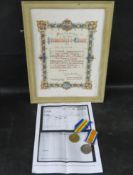 A pair of British WWI medals with citation.