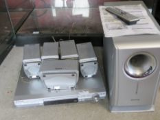 A Panasonic DVD home theatre sound system with remote and instructions.
