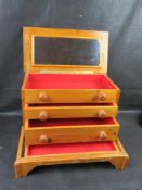 A pine jewellery box having 'hidden' bottom drawer.