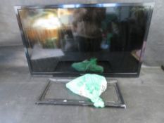 A Panasonic TV with cable and wall mount.