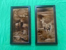 A pair of framed ceramic tiles having stag depiction upon, each 33 x 18cm.