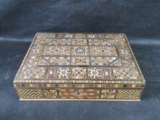 A handcrafted wood box featuring intricate geometric marquetry and mosaic inlay work.