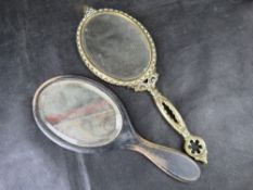 A vintage brass hand mirror and another similar.