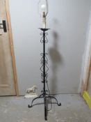 A wrought iron standard lamp