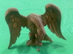 A carved and gilded eagle pediment top - possibly originally from a mirror, ball and chain in beak,
