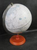 A tabletop globe on pine stand.