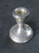 A hallmarked silver short candlestick.