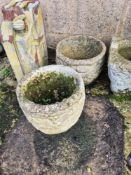 A pair of cast concrete garden pots.