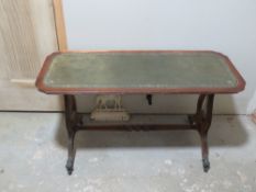 A leather topped occasional table having lyre supports.