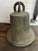 A cast metal bell having writing to crown of bell. Having cast iron ornate clapper and hanger.