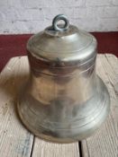 A 20th century cast bronze bell, top drilled, no discernible features, 19cm high, 24cm dia at mouth.
