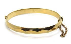 A 9ct gold metal core bangle, 19.5g.