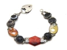 A finely made Scottish hardstone bracelet, each carved panel set in white metal,