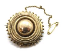 An antique pinchbeck brooch, having glazed locket verso, with safety chain, 7.