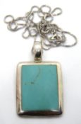 A large silver and turquoise pendant, 38mm in length on silver chain.