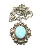 A large Taxco Mexican silver pendant set with oval turquoise cabachon,