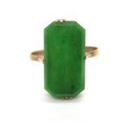 A vintage Jade ring, the octagonal cut flat panel of green jade in claw setting,